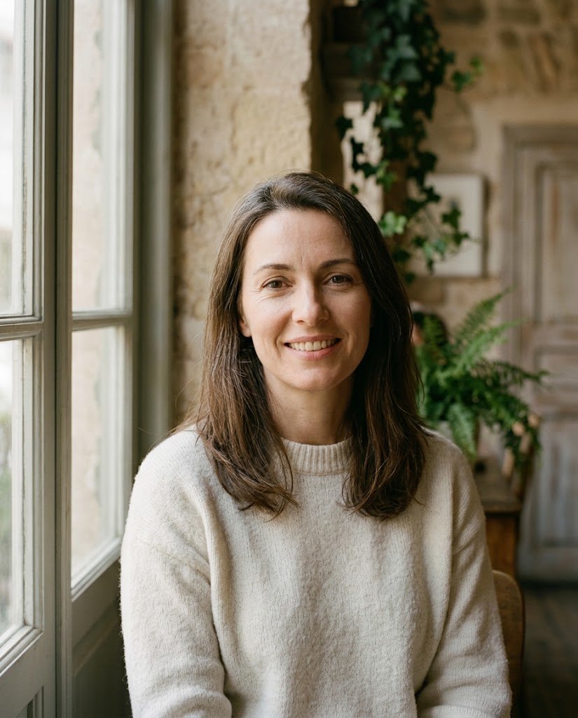 A woman in her forties with a natural, relaxed smile